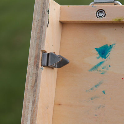 Close up of the clips that hold the painting in place